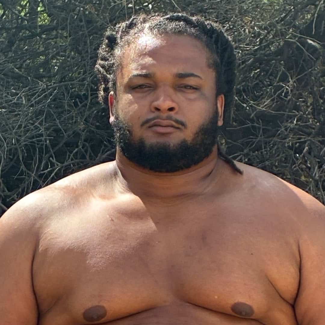 Close-up of a sumo wrestler with a serious expression.