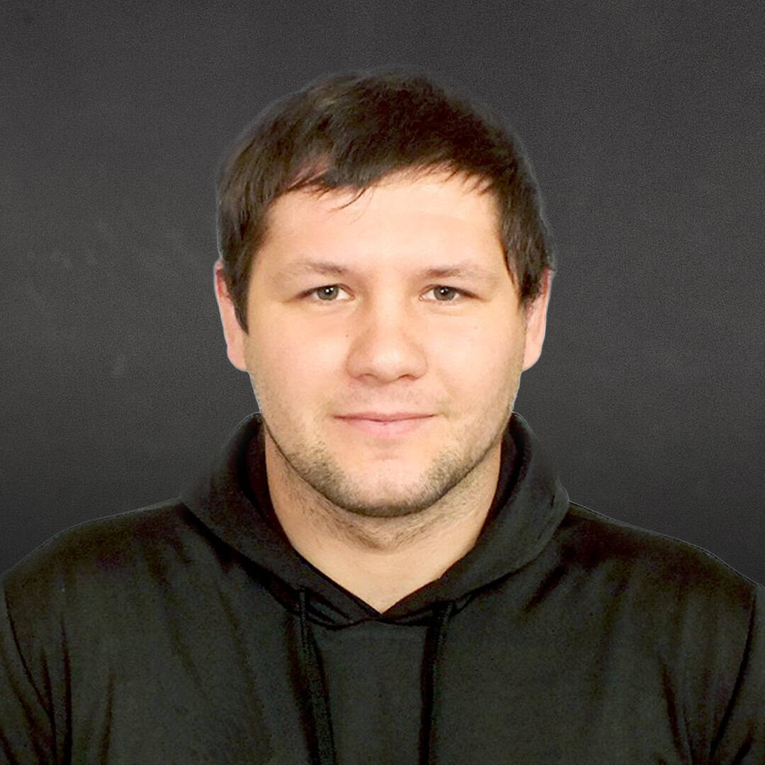 Portrait of Anton Chuiev with black background.
