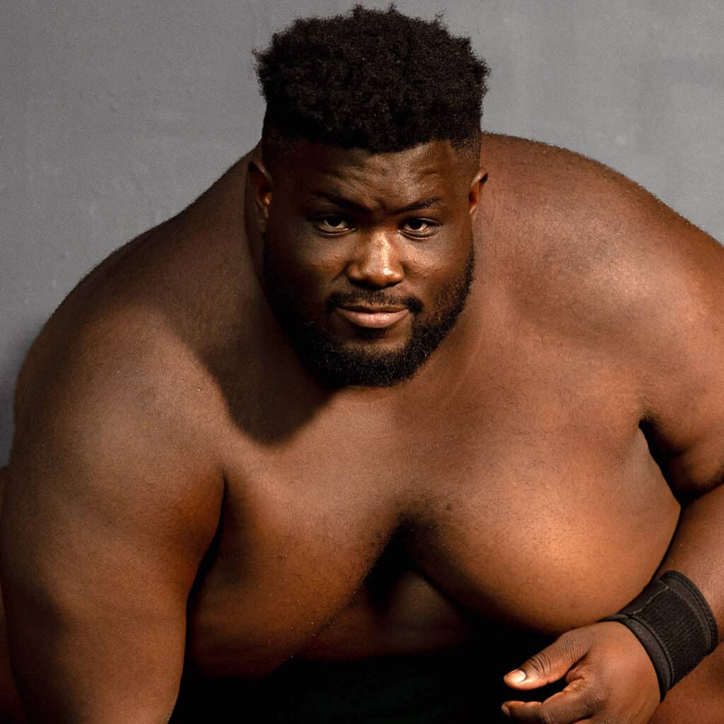 Sumo wrestler Dominus Davis-Williams shirtless with a serious expression.