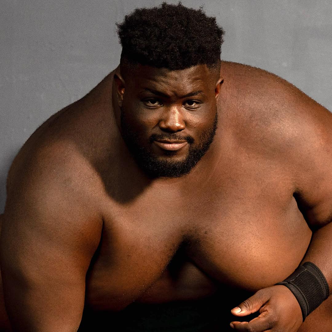 Sumo wrestler Dominus Davis-Williams shirtless with a serious expression.