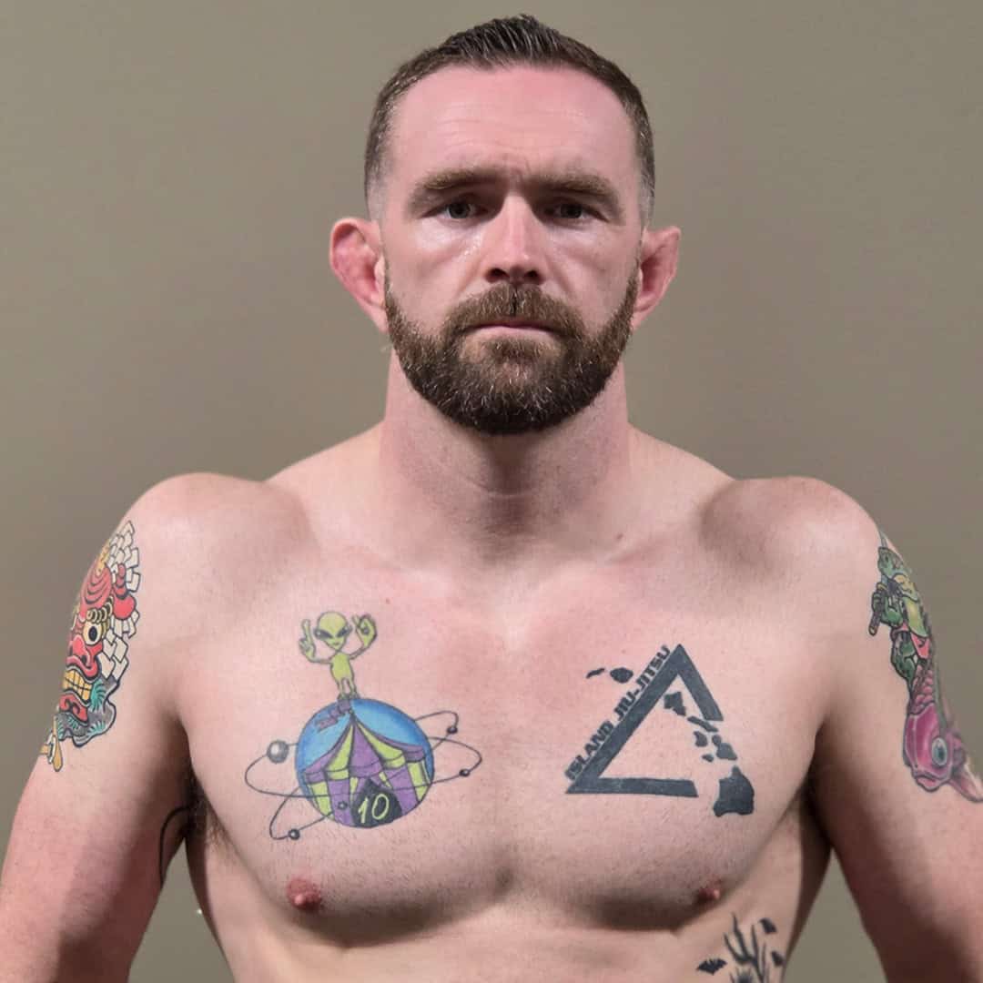 Sumo wrestler Matthew Cox with tattoos on his chest and arms.