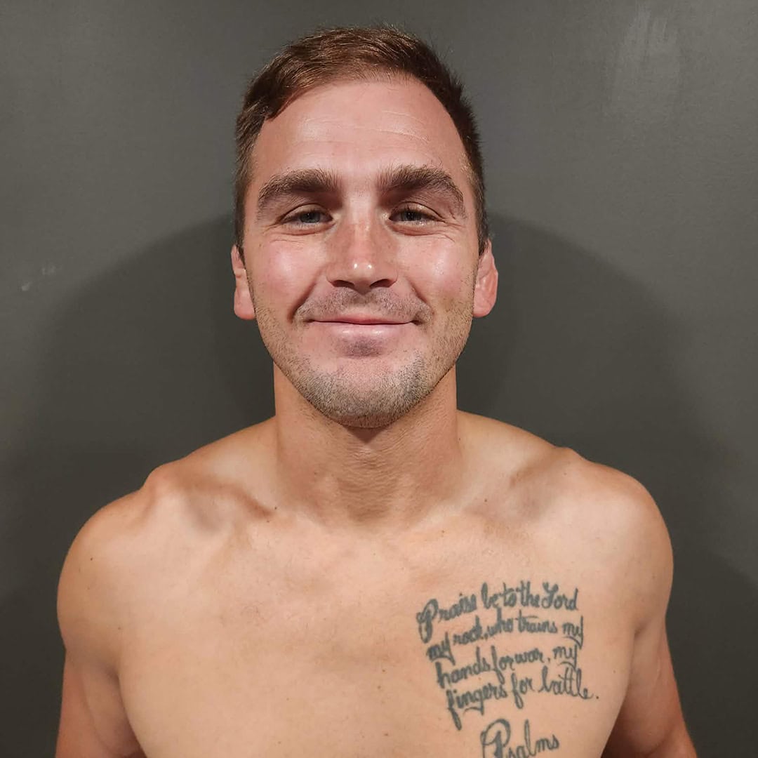 Portrait of Brandon Rudzinski with tattoo on chest.