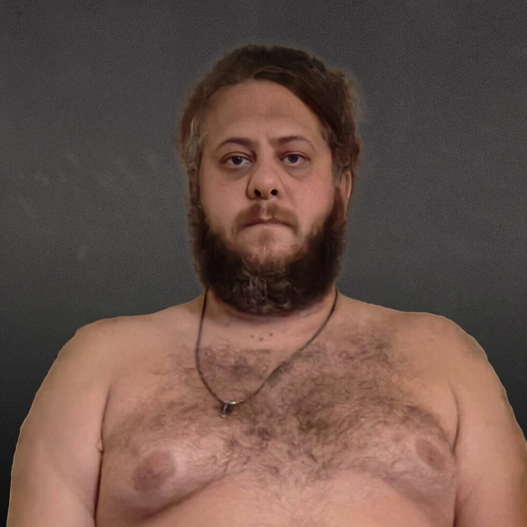 Sumo wrestler with beard and chest hair facing forward.