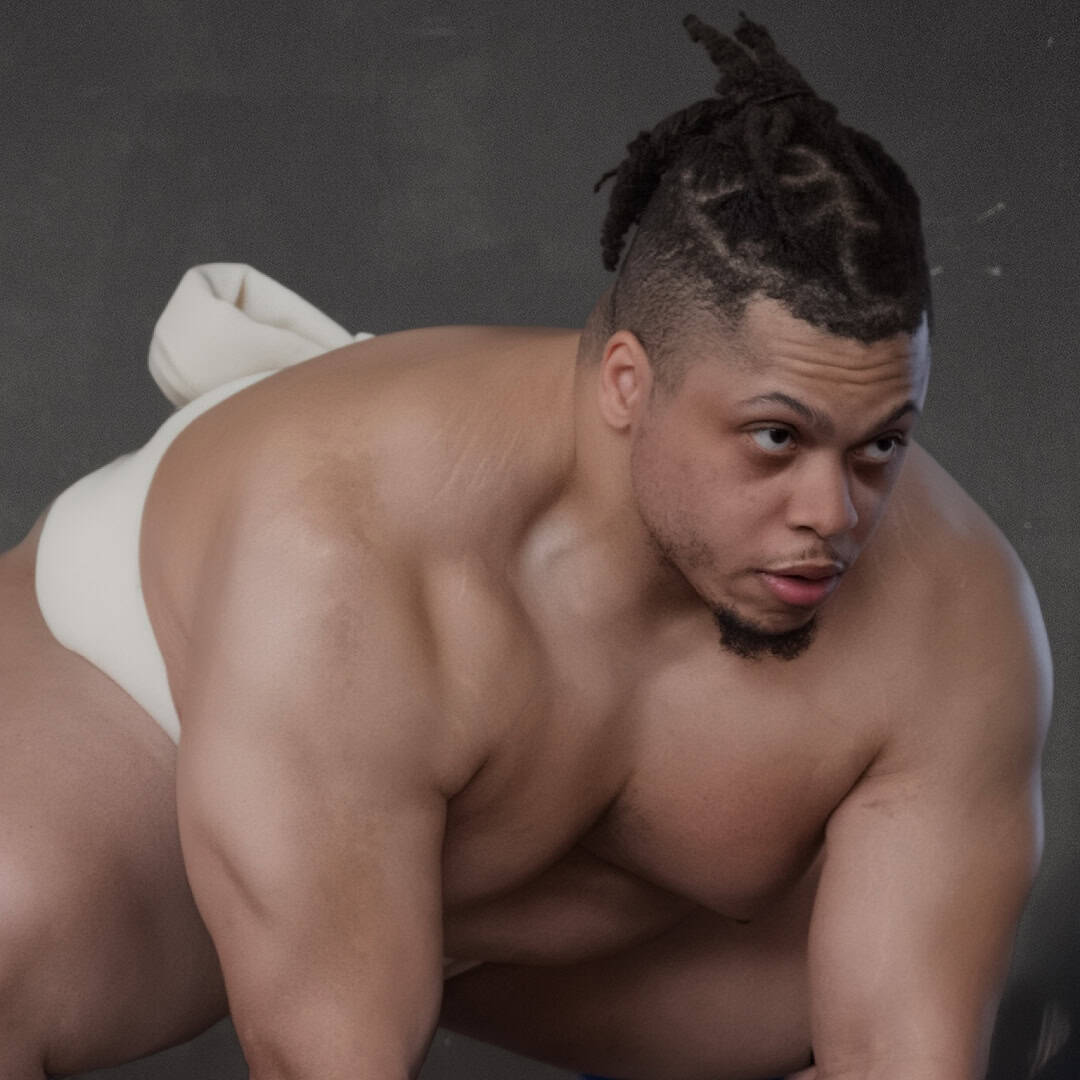 Sumo wrestler in a crouched stance with a focused expression.